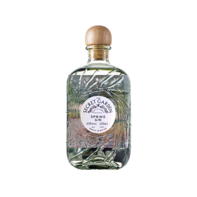 Bottle of 'The Secret Garden Distillery Spring Gin' on a white background